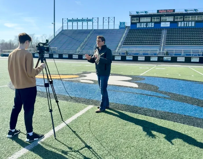 Kevin Jones of Empower Injury Law films student-led KLHS commercial at Liberty High School, supporting local schools and real-world learning.
